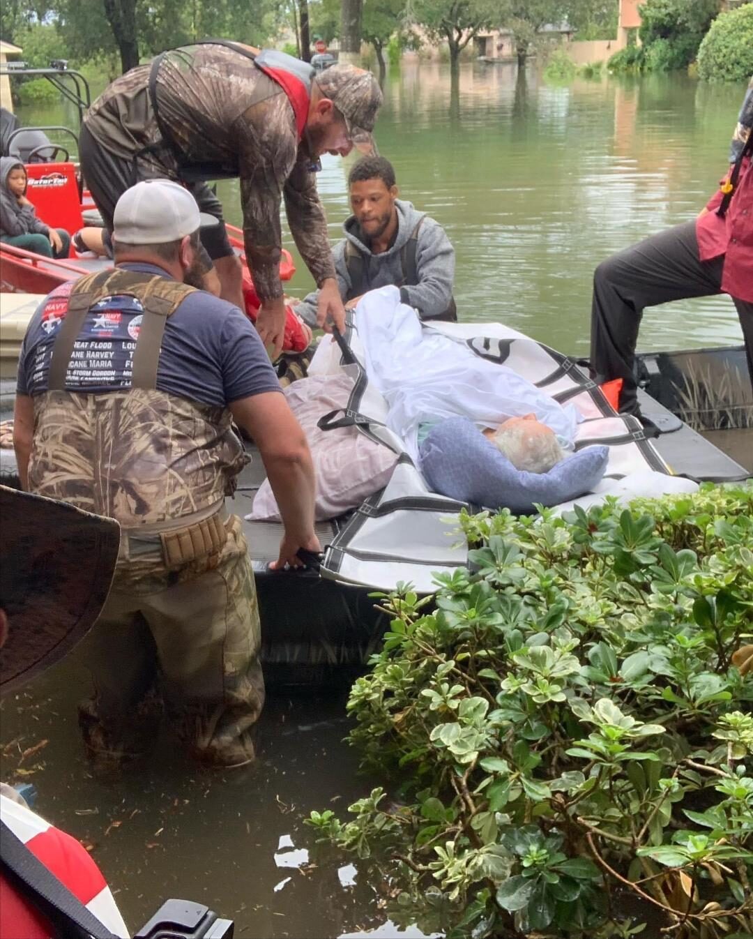 Ryan Nichols carrying flood victims to safety during a Texas hurricane rescue