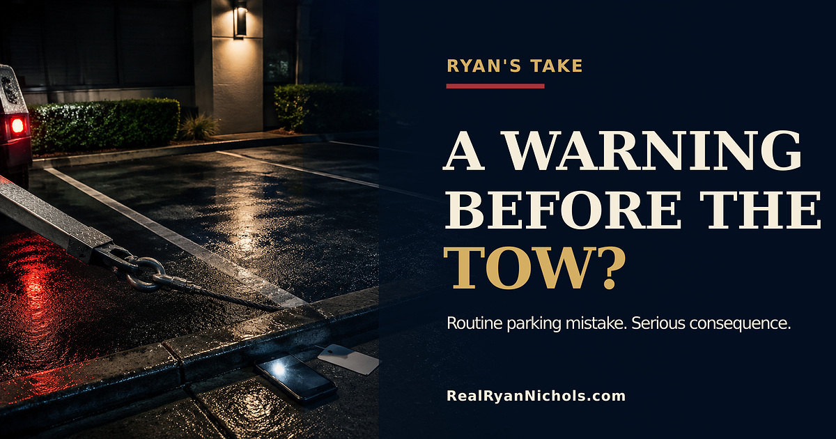 An apartment parking space at night with a tow hook, a resident permit, and a phone showing an unread alert