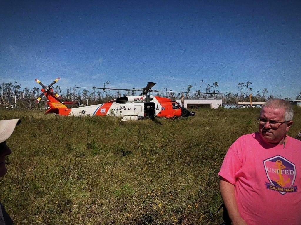 A Coast Guard helicopter on the ground with the rescue crew