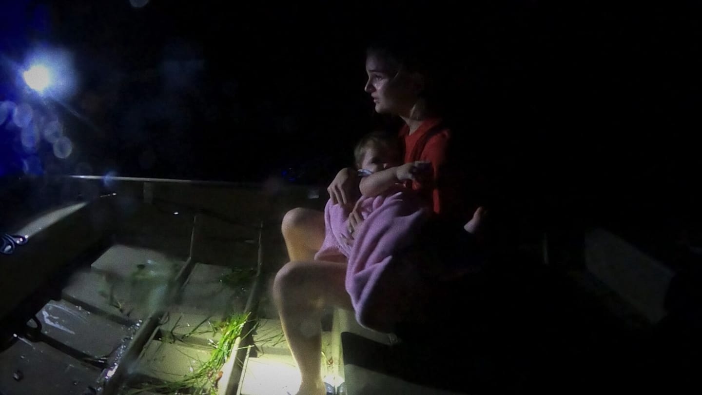A night rescue by flashlight, a mother and child in the boat
